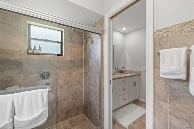 bathroom with vanity, walk in shower, and tile patterned flooring