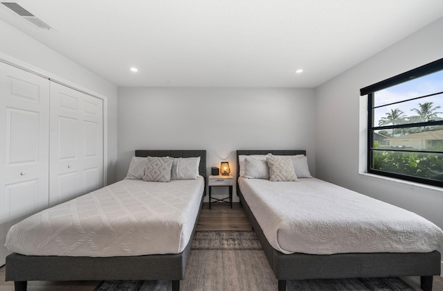 bedroom featuring dark hardwood / wood-style floors and a closet