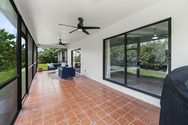 unfurnished sunroom with ceiling fan