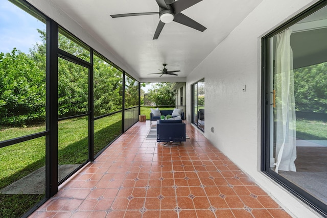 unfurnished sunroom with ceiling fan