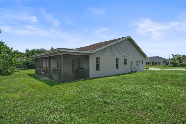 view of side of property with a sunroom and a yard