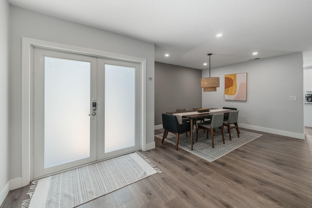 dining room featuring french doors and wood-type flooring