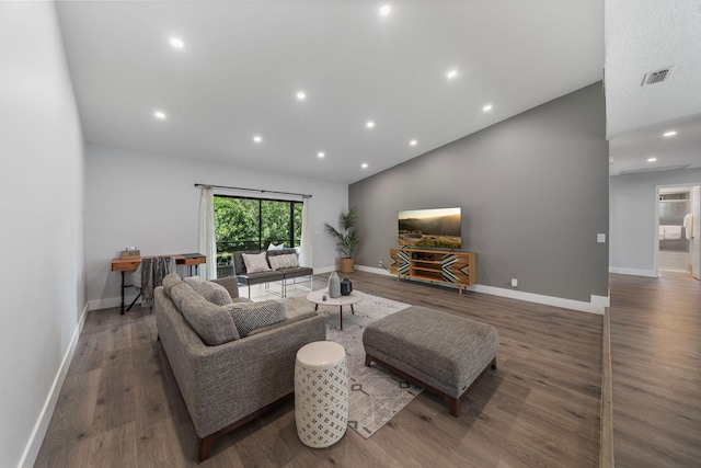 living room featuring hardwood / wood-style flooring and vaulted ceiling