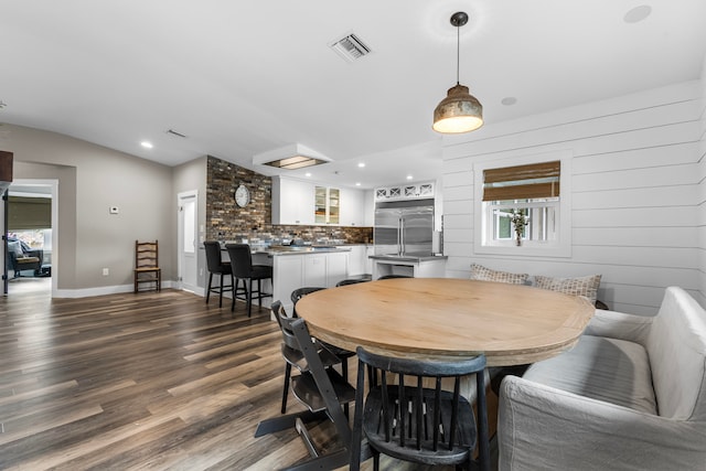 dining area featuring lofted ceiling and hardwood / wood-style floors