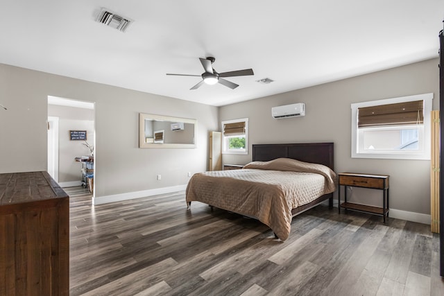 bedroom featuring ceiling fan, wood-type flooring, and a wall mounted AC