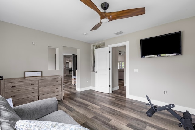 living room with ceiling fan and dark hardwood / wood-style floors