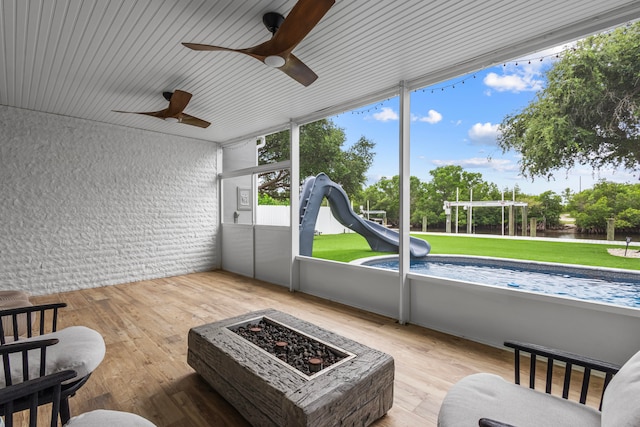 sunroom / solarium featuring ceiling fan