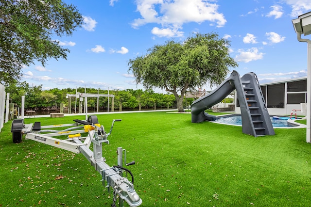 view of home's community with a playground and a lawn