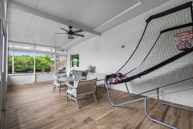 sunroom featuring ceiling fan and lofted ceiling