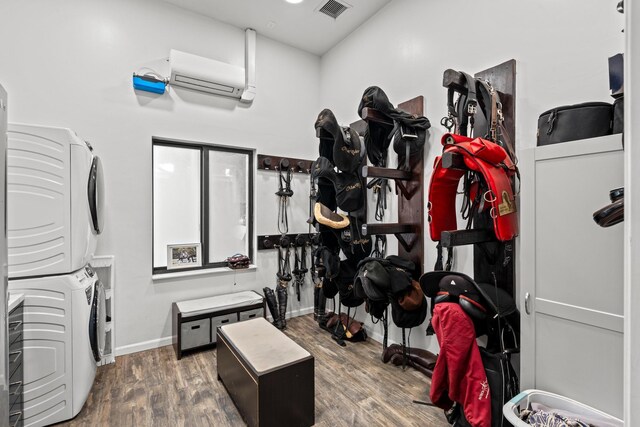 interior space with dark hardwood / wood-style floors and stacked washer and dryer