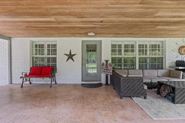 view of exterior entry with outdoor lounge area and a patio