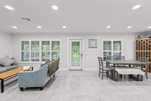 dining area with ornamental molding and a wealth of natural light