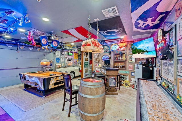 playroom with concrete flooring, pool table, and indoor bar