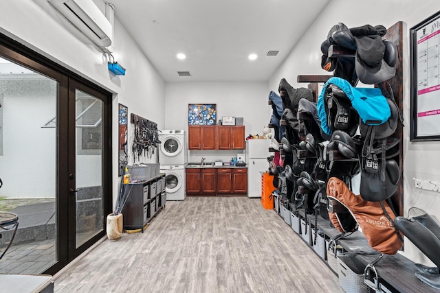 storage featuring sink and stacked washer / dryer