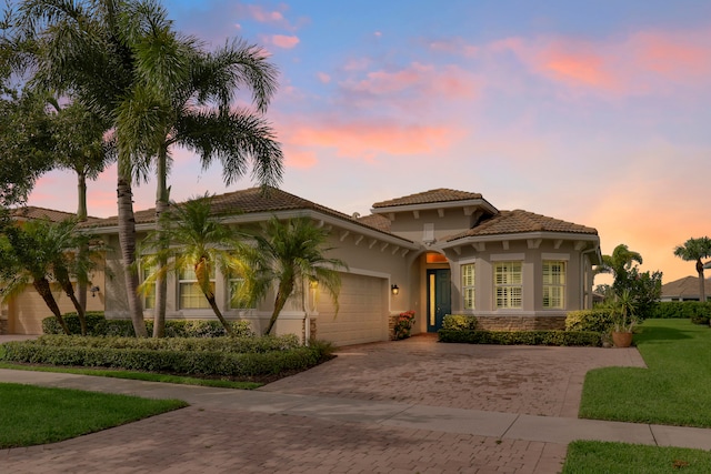 mediterranean / spanish-style home with a garage