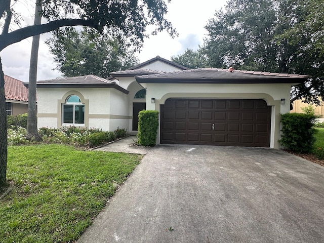 view of front of property with a front lawn and a garage