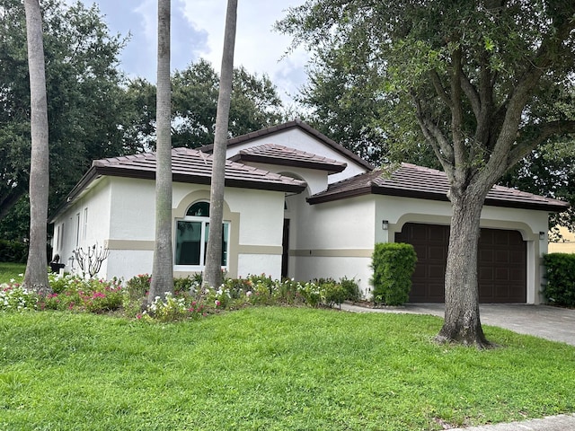 view of front of property with a front yard and a garage