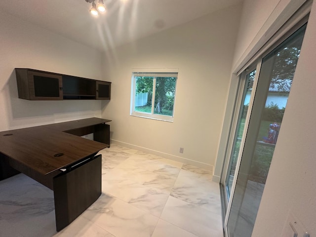 unfurnished office featuring vaulted ceiling