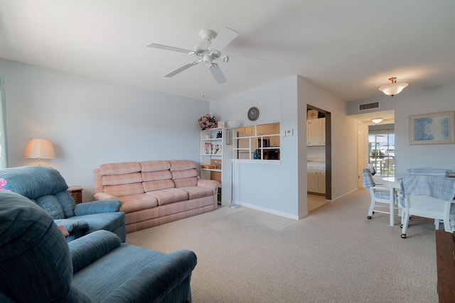 carpeted living room featuring ceiling fan