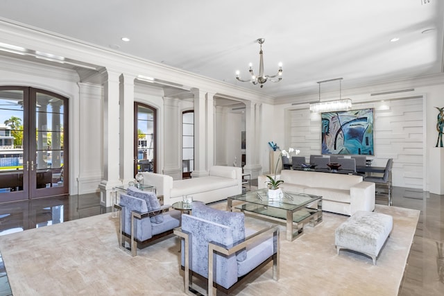 living room featuring a wealth of natural light, french doors, a chandelier, and ornamental molding