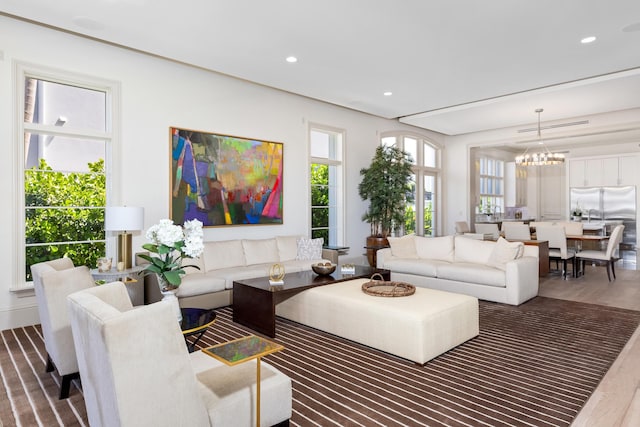 living room featuring hardwood / wood-style floors and a notable chandelier