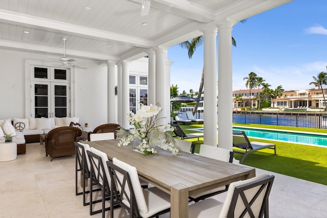 view of patio / terrace featuring a fenced in pool, outdoor lounge area, ceiling fan, and a water view