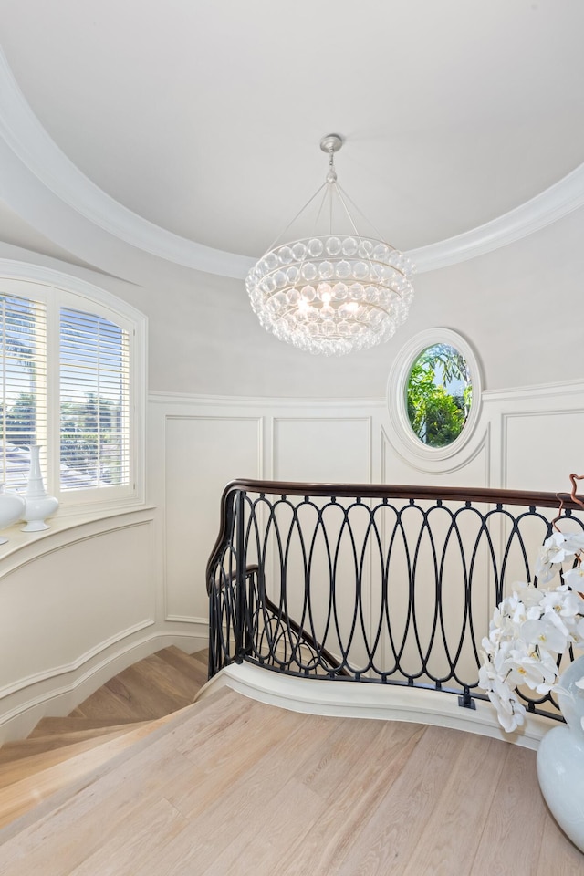 bedroom featuring light hardwood / wood-style floors, an inviting chandelier, and ornamental molding