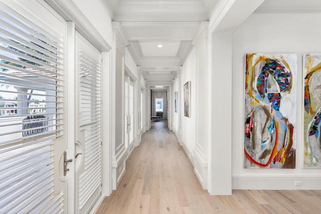 hallway with beam ceiling, light hardwood / wood-style floors, crown molding, and coffered ceiling