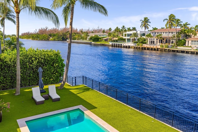 view of pool featuring a water view and a lawn