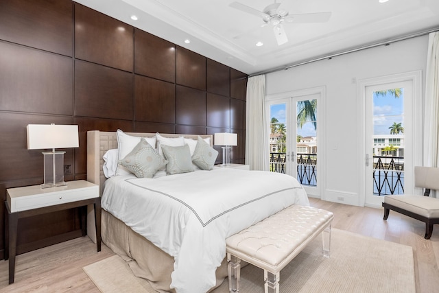 bedroom featuring access to exterior, french doors, light hardwood / wood-style flooring, and ceiling fan