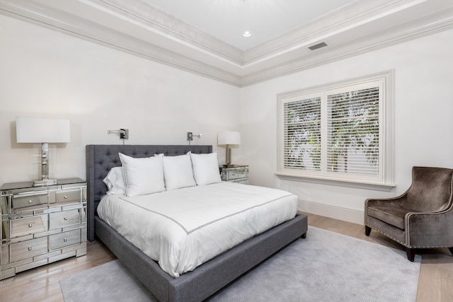 bedroom featuring light hardwood / wood-style floors and ornamental molding