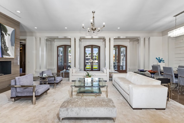 living room featuring decorative columns, an inviting chandelier, ornamental molding, and french doors