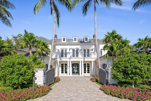 view of front facade with a balcony and french doors