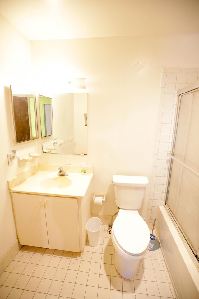 full bathroom with vanity, toilet, shower / bath combination with glass door, and tile patterned flooring