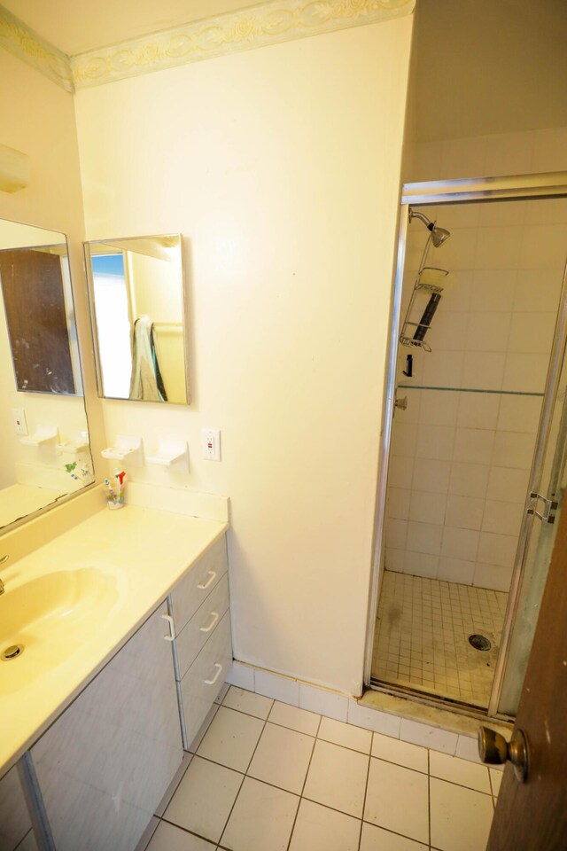 bathroom featuring an enclosed shower, tile patterned floors, and vanity