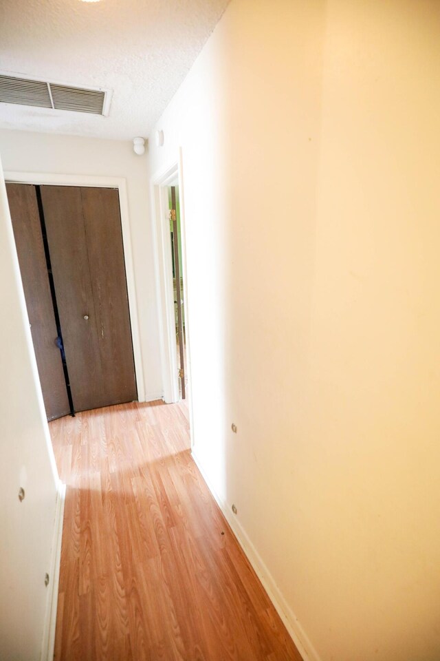 corridor featuring light hardwood / wood-style floors