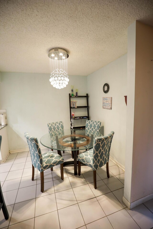 living area with light tile patterned flooring, a textured ceiling, and an inviting chandelier