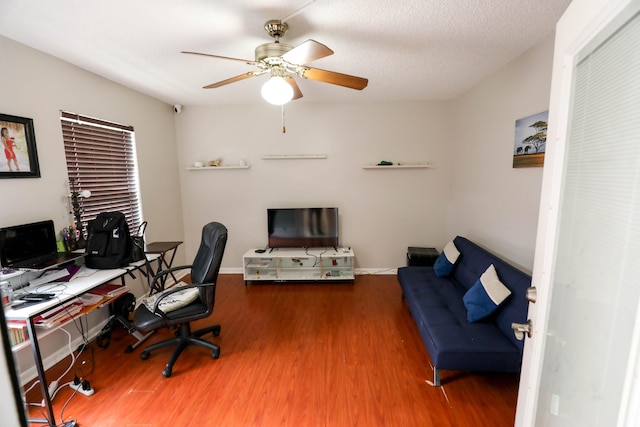 office area with a textured ceiling, hardwood / wood-style floors, and ceiling fan