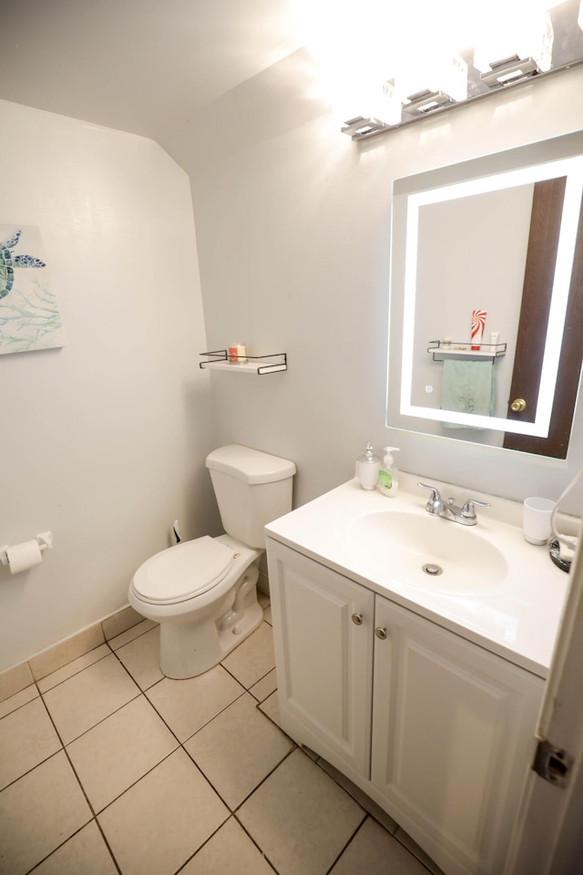 bathroom featuring toilet, tile patterned floors, and vanity