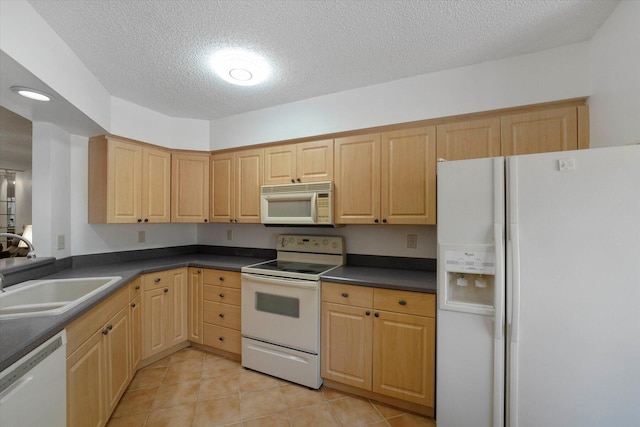 kitchen featuring white appliances, light tile patterned floors, sink, and light brown cabinets