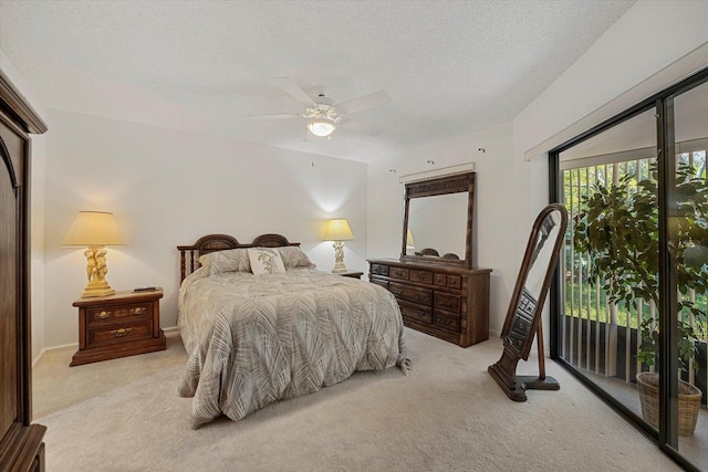 carpeted bedroom featuring access to exterior, a textured ceiling, and ceiling fan