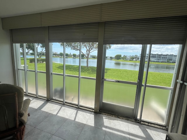 unfurnished sunroom featuring a water view