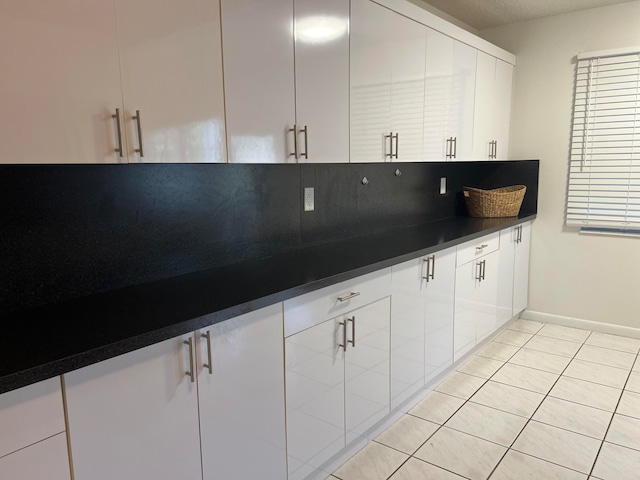 kitchen with white cabinetry and light tile patterned floors