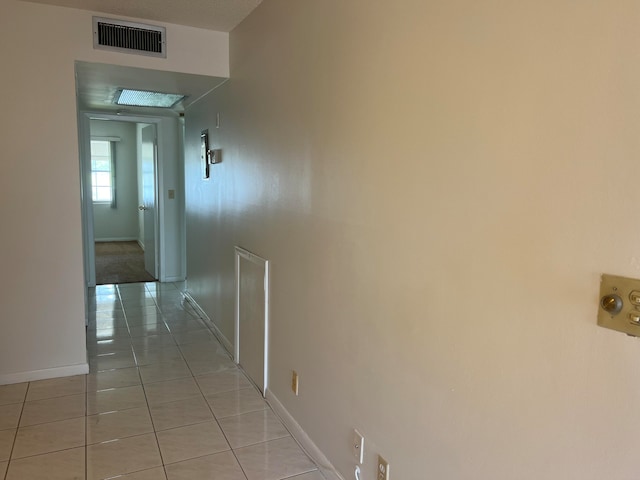 hallway featuring light tile patterned flooring