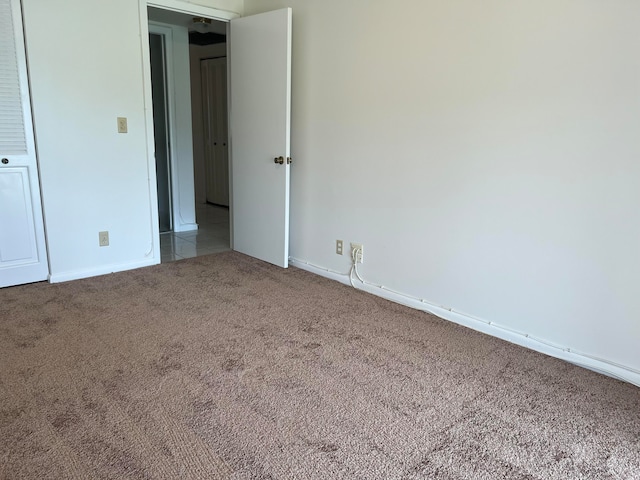 unfurnished room featuring light carpet