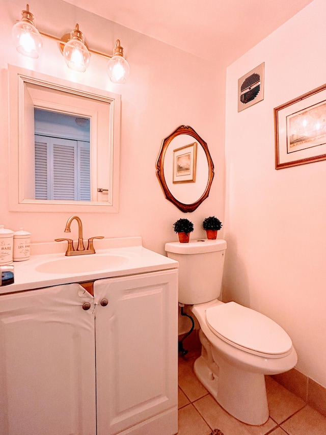 bathroom with vanity, toilet, and tile patterned floors