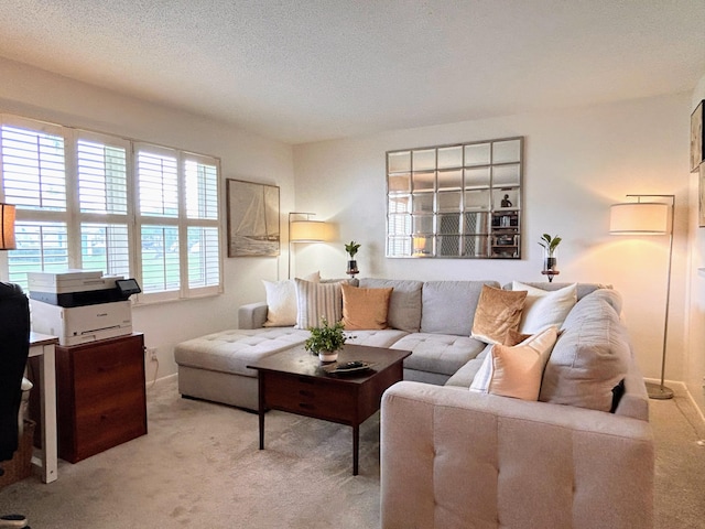 living room featuring light carpet and a textured ceiling