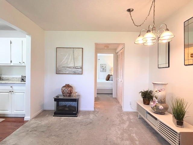 320 Horizons W Unit 103, Boynton Beach, FL 33435 - hall with carpet floors, baseboards, and a chandelier