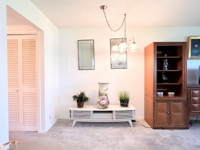 320 Horizons W Unit 103, Boynton Beach, FL 33435 - hall with carpet floors, a chandelier, and baseboards