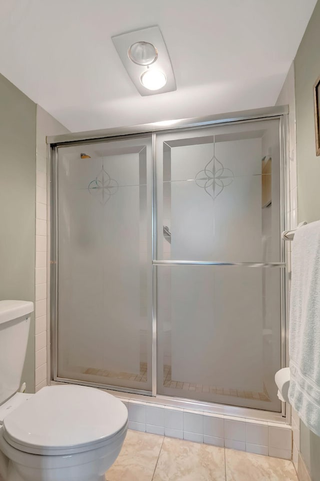 bathroom with toilet, an enclosed shower, and tile patterned flooring